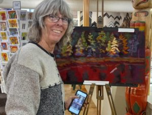 A photo of Terry in front of a pastel landscape